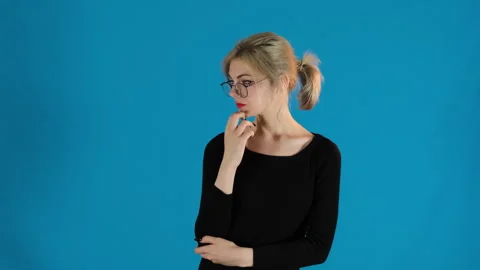 Pensive blonde model puts head on hand thinking Stock Footage 306479477