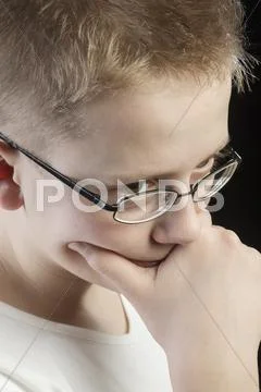 Pensive boy with hand on chin Stock Photos