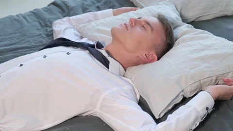 Pensive business man dreaming while lying in bed Stock Footage 160549305