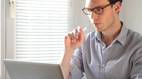Pensive business man working on computer in office Stock Footage 98100684
