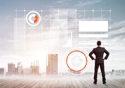 Pensive businessman looking at user interface against modern city background 스톡 사진