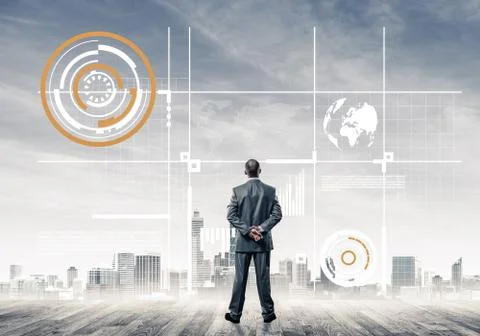Pensive businessman looking at user interface against modern cit 스톡 사진