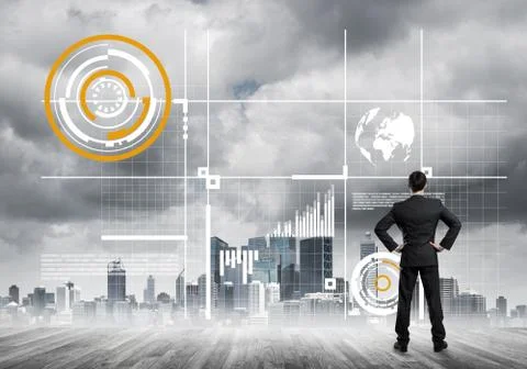 Pensive businessman looking at user interface against modern city background 스톡 사진
