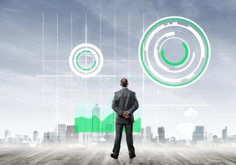 Pensive businessman looking at user interface against modern city background 스톡 사진