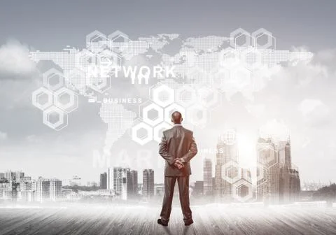 Pensive businessman looking at user interface against modern cit 스톡 사진