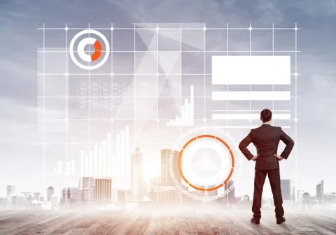Pensive businessman looking at user interface against modern city background 스톡 사진