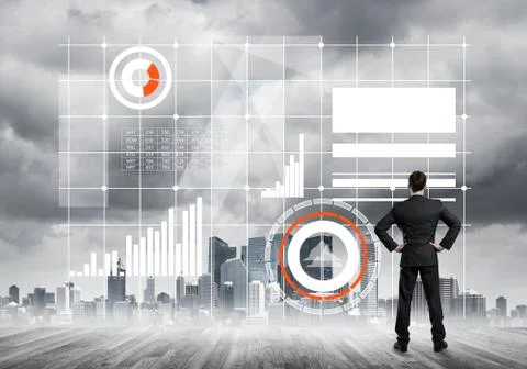 Pensive businessman looking at user interface against modern city background 스톡 사진