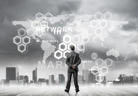 Pensive businessman looking at user interface against modern cit 스톡 사진