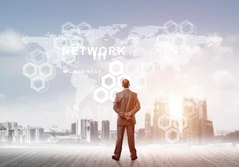 Pensive businessman looking at user interface against modern city background 스톡 사진