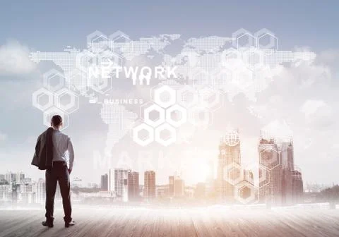 Pensive businessman looking at user interface against modern city background Foto stock