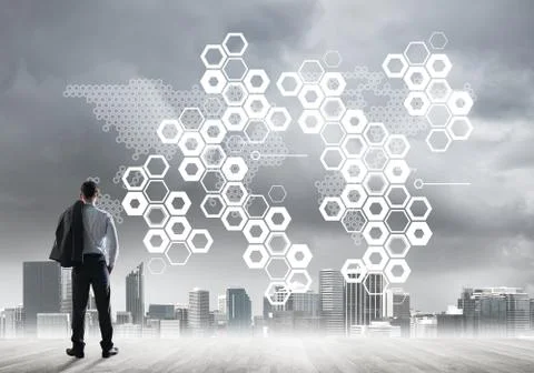 Pensive businessman looking at user interface against modern city background Foto stock