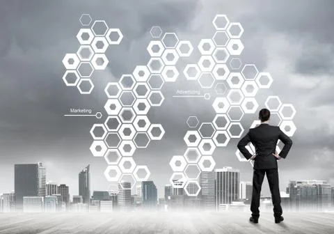 Pensive businessman looking at user interface against modern city background 스톡 사진