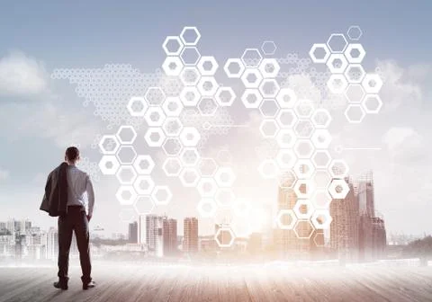 Pensive businessman looking at user interface against modern city background 스톡 사진