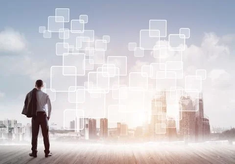 Pensive businessman looking at user interface against modern city background 스톡 사진