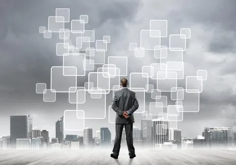 Pensive businessman looking at user interface against modern city background 스톡 사진