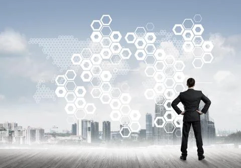 Pensive businessman looking at user interface against modern city background 스톡 사진