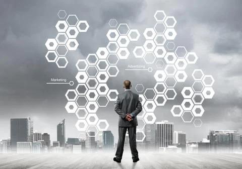Pensive businessman looking at user interface against modern city background 스톡 사진