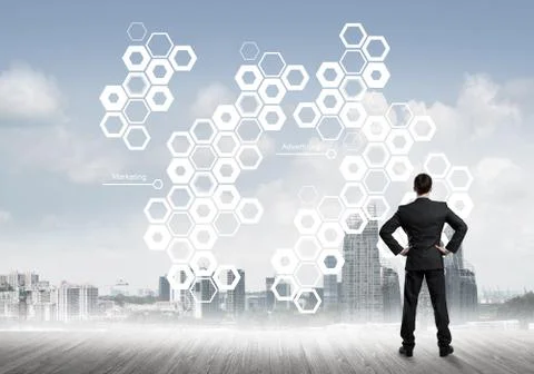 Pensive businessman looking at user interface against modern city background 스톡 사진