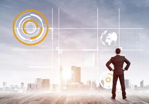 Pensive businessman looking at user interface against modern city background 스톡 사진
