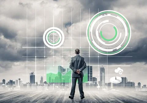 Pensive businessman looking at user interface against modern city background 스톡 사진