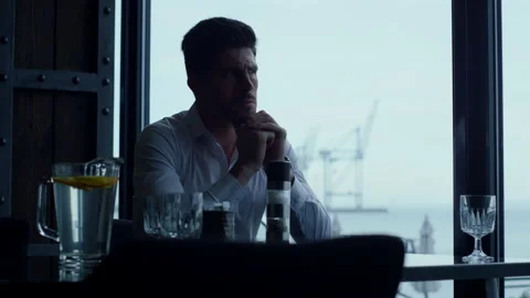 Pensive businessman thinking problem solution in dark restaurant interior alone Stock Footage 201787904