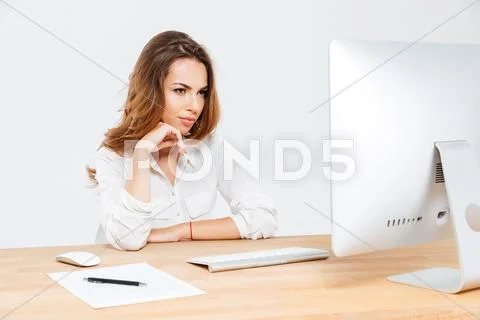Pensive businesswoman thinking about something and looking at laptop Stock Photos