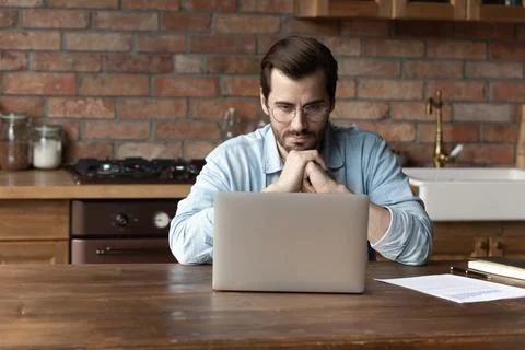 Pensive Caucasian man work on computer thinking Stockfoto's