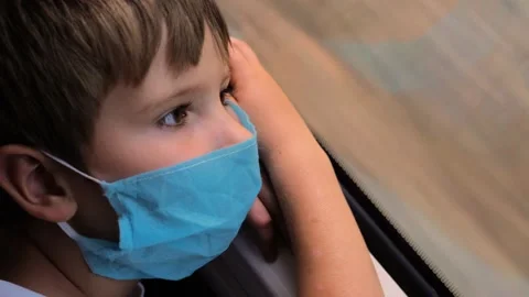Pensive child looking in the window during train ride. Face of kid in madical Stock-Footage 141037902