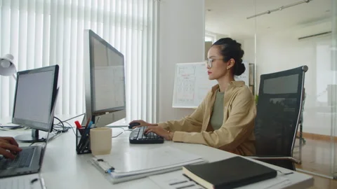 Pensive Coders Developing Software Equipment Using Office Computers Stock Footage 256978797