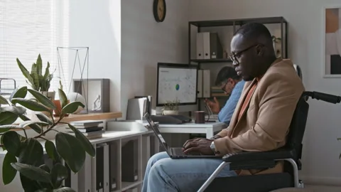 Pensive Company Worker in Wheelchair Developing Project on Laptop Video stock 283761047