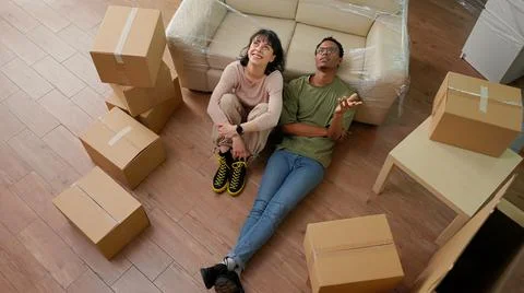Pensive couple thinking about future in new apartment flat Stock Photos