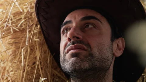 Pensive cowboy on hay. Close up Stock Footage 258564993