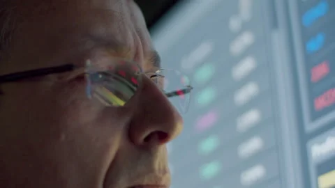 Pensive data engineer looking at digital monitor Stock Footage 231578172