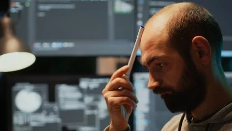 Pensive database admin brainstorming ideas in office Stock Photos