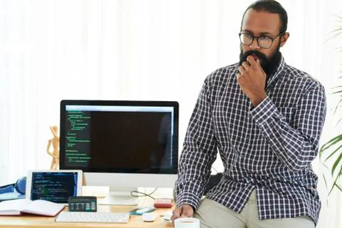 Pensive developer has a coffee break Stock Photos
