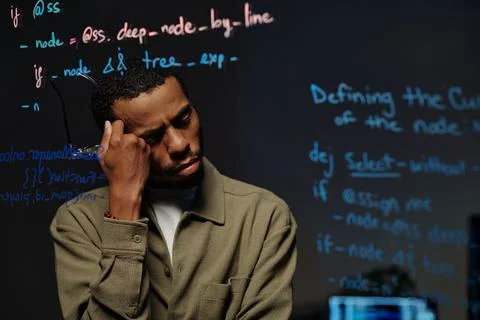 Pensive Developer Reading Code on Transparent Screen Stock Photos