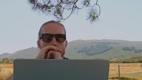 Pensive Digital Nomad Thinking Deeply at Laptop Stock Footage 344809172