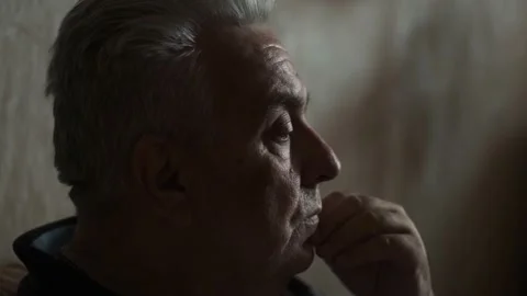 Pensive elderly gray-haired man thinks about something, close-up 動画素材 194247426