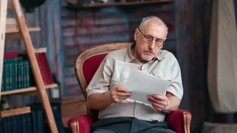 Pensive elderly man reading paper document retirement banking healthcare Video stock 180061870