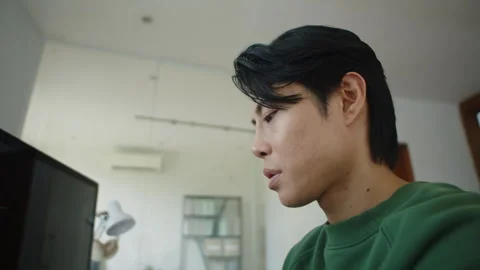 Pensive Employee Writing Code Using Laptop at Desk in Office Stock Footage 256974923