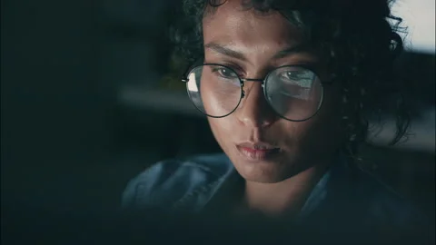 Pensive Female Coder Reviewing Code at Night with Reflection in Glasses. Stock Footage 307586964