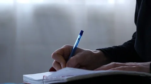 Pensive female student makes notes in a notebook or diary. 4K Stock Footage 88458600