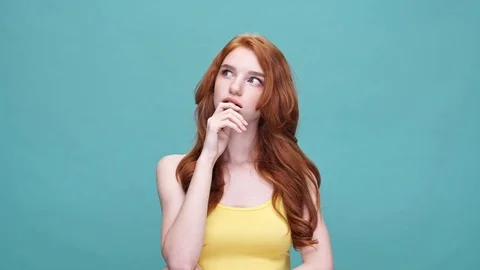 Pensive girl having an idea while thinking isolated Stock Footage