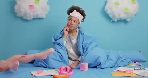 Pensive good looking female model looks around pensively has deep thoughts wears Stock Footage 148421269