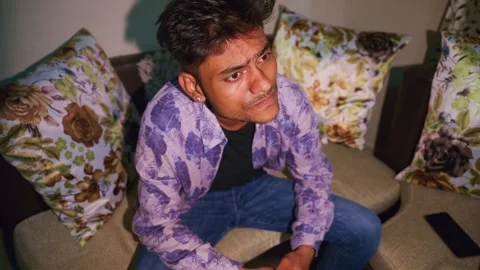 Pensive guy with deep reflection sits at bedroom Stock Footage 302634156