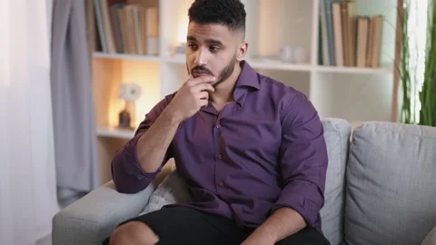 Pensive guy home contemplation sad man on couch Stock Footage 201514066