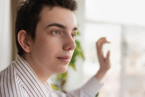 Pensive guy looking out window at home Stock Photos