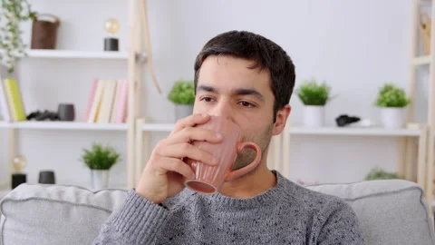 Pensive hispanic man drinking coffee Video stock 262383515