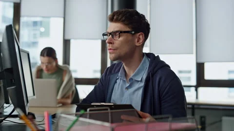 Pensive it guy solving code problem. Startup engineer analyzing software code Stock Footage 242986922