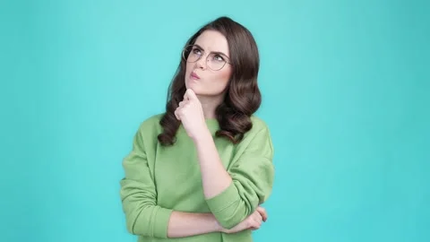 Pensive lady deep thought decide solution isolated cyan color background Stock Footage 169944200